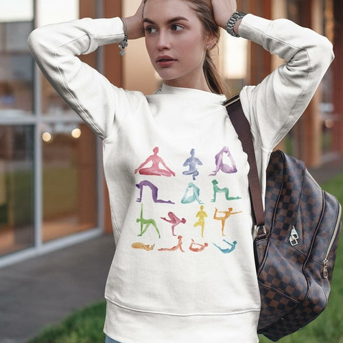 Woman wearing Yoga Theme Crewneck Sweatshirt with colorful yoga poses printed on soft white loose fit fabric