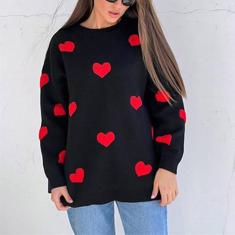 Woman wearing a black Printed Heart Knitted Sweater with red hearts paired with blue jeans in casual women clothes style