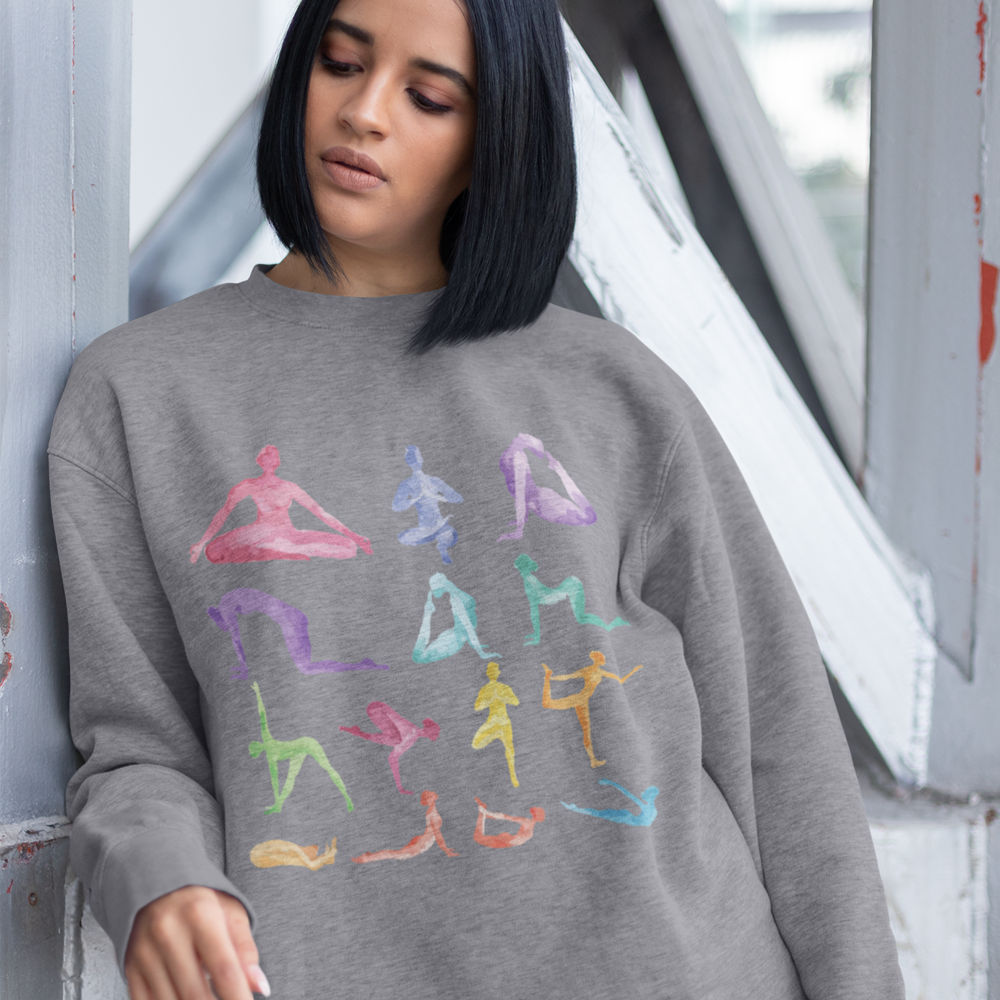 Woman wearing Yoga Theme Crewneck Sweatshirt with colorful yoga poses printed on soft gray fabric in relaxed fit style