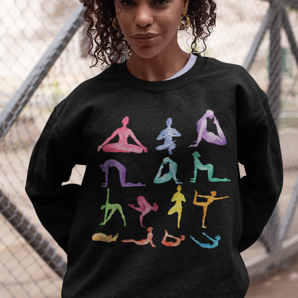 Woman wearing Yoga Theme Crewneck Sweatshirt with multicolor yoga poses print on black loose fit fabric